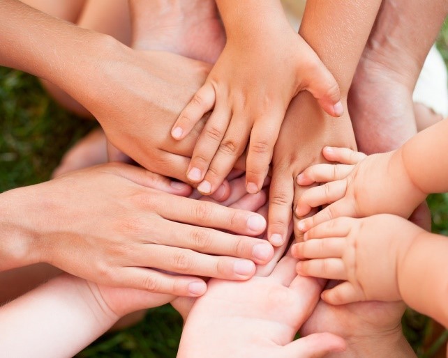 An image showing lots of hands, both adult and children
